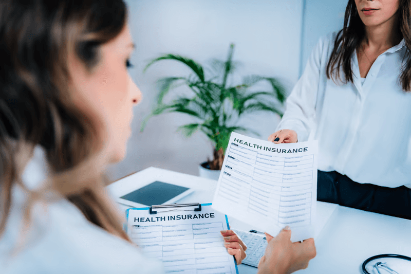 Person reviewing recovery health insurance document