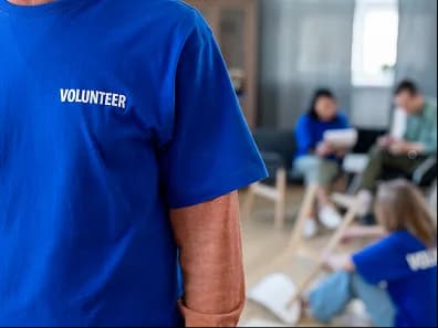 Volunteers in matching shirts at a meeting