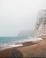 Chalk cliffs above a misty beach