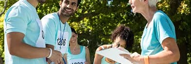 Charity runners wearing numbered bibs