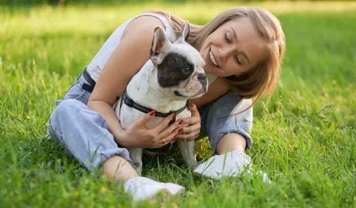 Woman with her dog outdoors, representing facility boarding