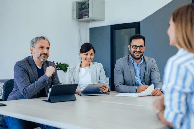 Interviewer and candidate having thoughtful discussion in modern office setting