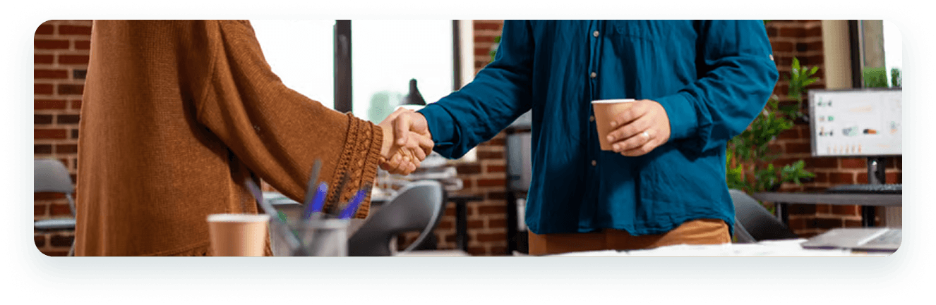 Partners shaking hands over a meeting table