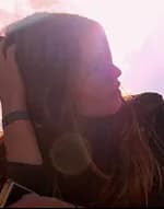 A woman in warm sunlight