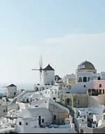 Whitewashed hillside buildings and a windmill