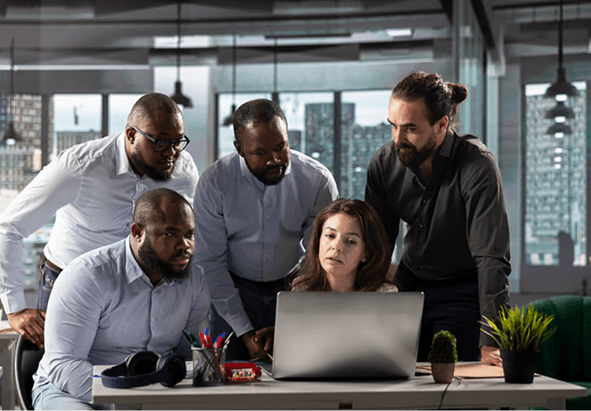 An organization team planning an event around a laptop