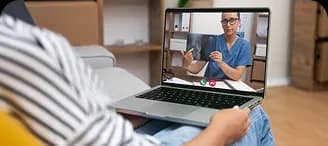 A person on a video visit with a clinician on a laptop