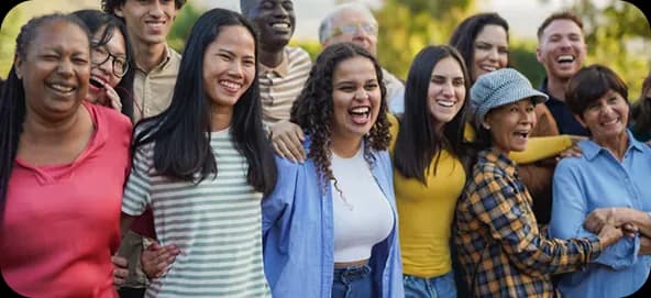 A large, diverse group of smiling people outdoors
