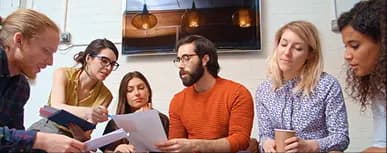 A team reviewing documents together around a table